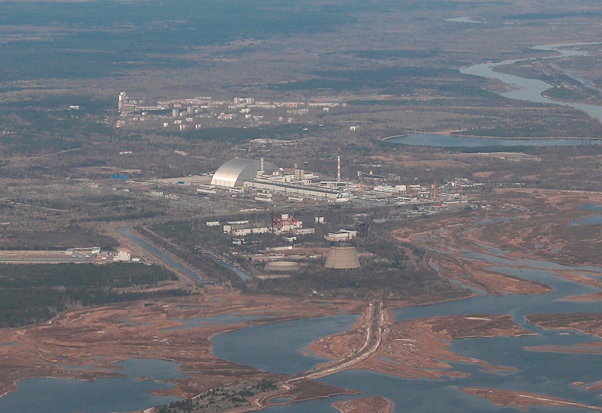 An aerial view from a plane shows a New Safe Confinement (NSC) structure over the old sarcophagus covering the damaged fourth reactor at the Chernobyl Nuclear Power Plant. - REUTERS/Gleb Garanich/File Photo