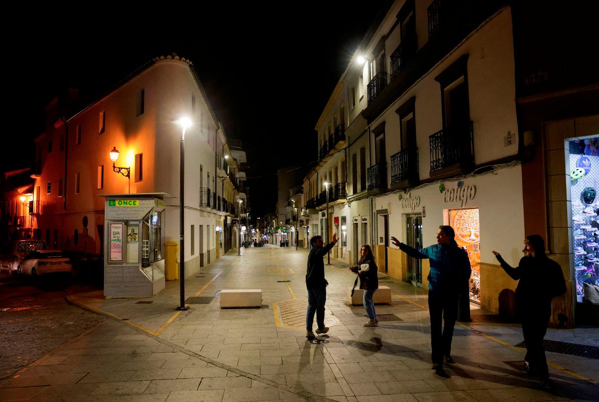 Friends greet each other in an illuminated shopping street a day after a sudden major blackout in the Iberian Peninsula, in Ronda, Spain, April 29, 2025. - REUTERSPIX