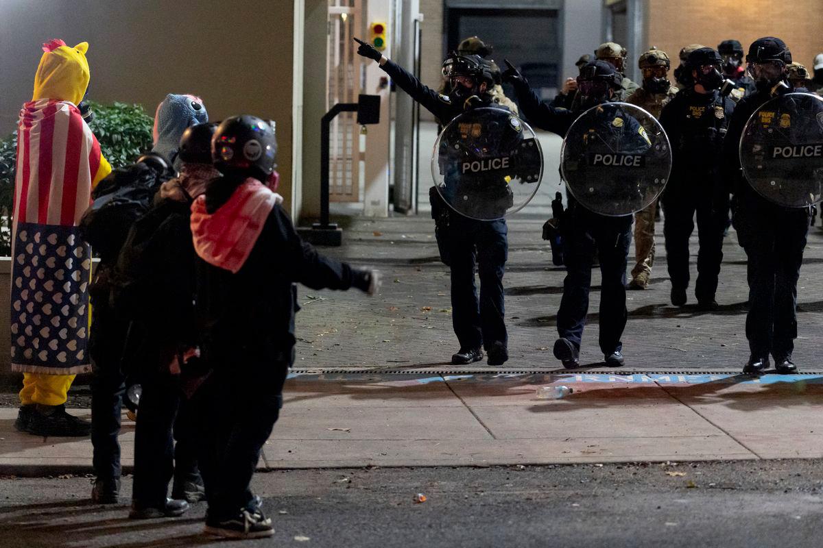 Law enforcement officers disperse protesters outside the ICE (Immigration and Customs Enforcement) headquarters in South Portland, Oregon, U.S., October 2, 2025. - REUTERSPIX