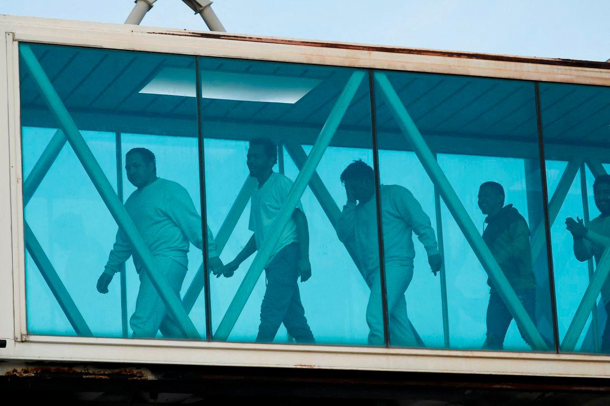 Venezuelan migrants react after arriving on a deportation flight from the United States at Simon Bolivar International Airport, in Maiquetia, Venezuela May 9, 2025. - REUTERSPIX
