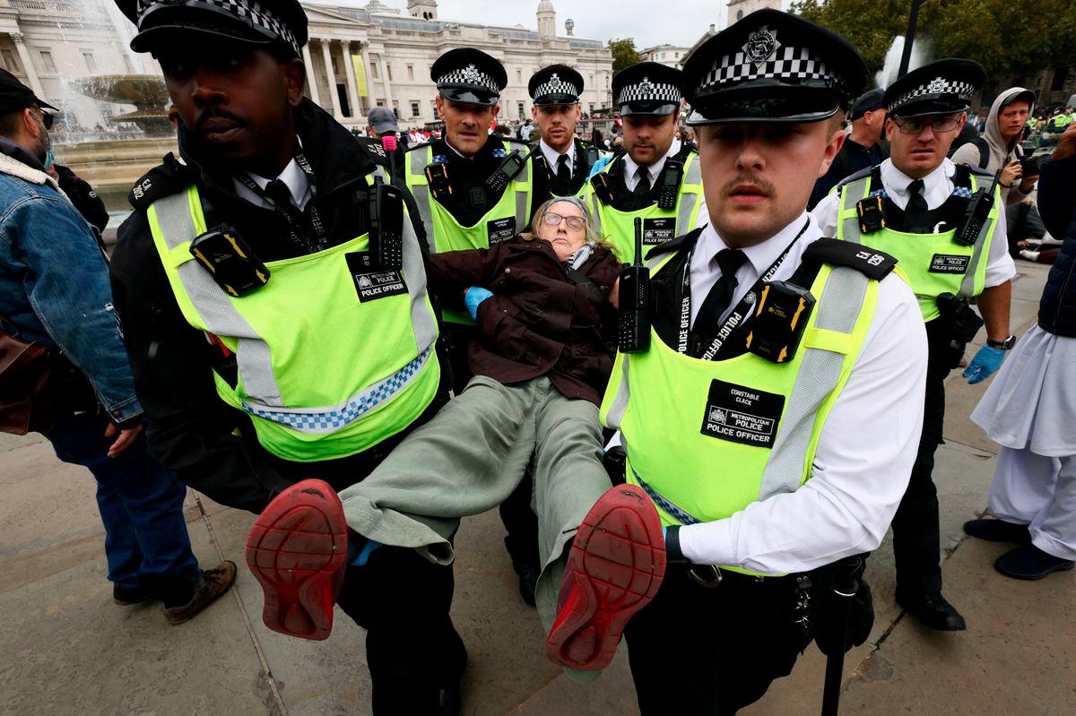 Police officers detain a protester during a mass demonstration organised by Defend our Juries, against the British government’s ban on Palestine Action in London, Britain, October 4, 2025. REUTERS/Jack Taylor