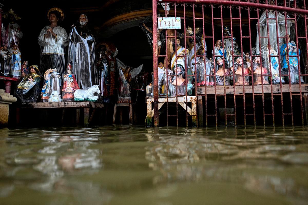 For visual purposes only: Religious statues made of resin are displayed at a flooded shop, intensified by rain caused by Severe Tropical Storm Matmo, in San Roque, Macabebe, Pampanga, Philippines, October 4, 2025. REUTERS/Noel Celis