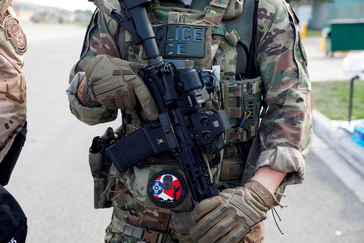 For visual purposes only: FILE PHOTO: A U.S. Immigration and Customs Enforcement officer holds a weapon during a protest outside an ICE facility, weeks after President Donald Trump ordered increased federal law enforcement presence and stepped-up immigration enforcement actions by the Department of Homeland Security, in Broadview, Illinois, U.S., September 12, 2025. REUTERS/Octavio Jones/File Photo
