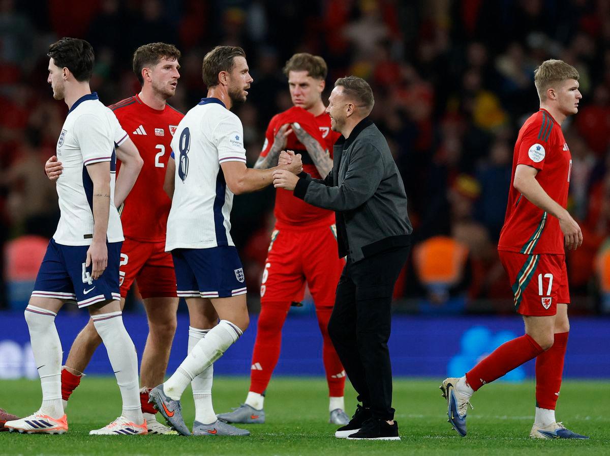 England’s Jordan Henderson shakes hands with Wales manager Craig Bellamy after the match Action Images via Reuters/Peter Cziborra