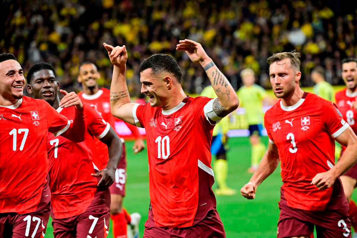 Switzerland’s Granit Xhaka celebrates scoring their first goal with teammates Jonas Ekstromer/TT News Agency via REUTERS