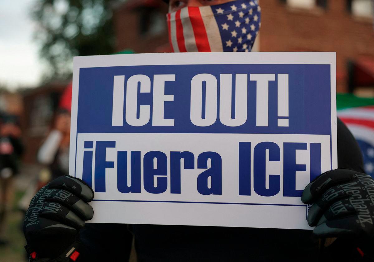 A demonstrator holds a sign during a protest against federal immigration action, outside the U.S. Immigration and Customs Enforcement (ICE) Broadview facility in Chicago, Illinois, U.S., October 10, 2025. - REUTERS