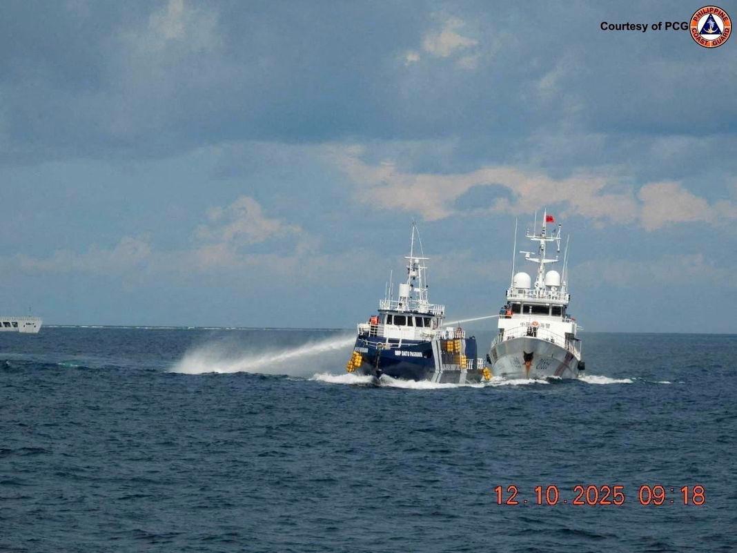 A China Coast Guard vessel 21559 uses a water cannon against Philippines Bureau of Fisheries and Aquatic Resources ship BRP Datu Pagbuaya in the South China Sea, in this handout image released by the Philippine Coast Guard on October 12, 2025. - Philippine Coast Guard/Handout via REUTERSPIX