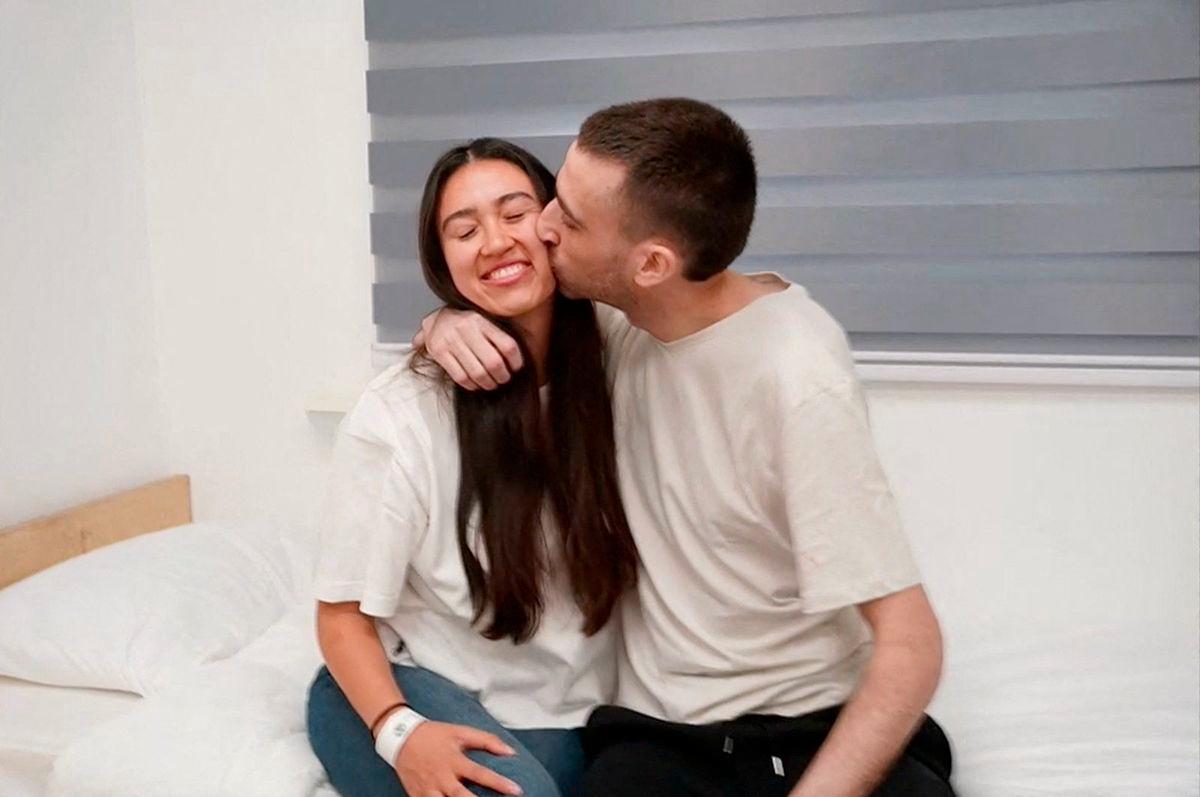 Released Israeli hostage, Avinatan Or, held in Gaza since the deadly October 7, 2023 attack by Hamas, kisses his girlfriend, Noa Argamani, who was also taken hostage and rescued in 2024, after his release as part of a prisoner-hostage swap and a ceasefire deal between Israel and Hamas, in Reim, Israel October 13, 2025. - Courtesy of Israel Defense Forces/Handout via REUTERSPIX