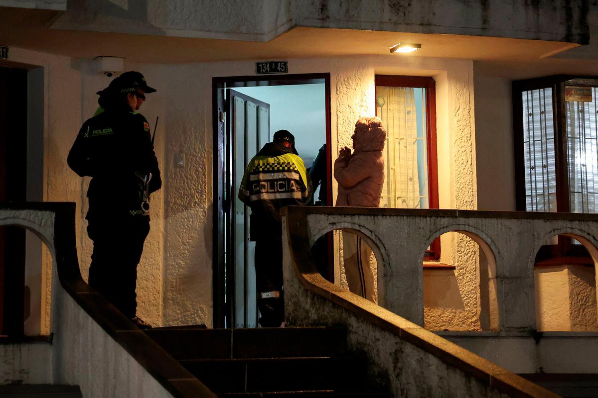 Neighbors of a house adjacent to the place where Venezuelan human rights activist Yendri Velasquez and political consultant Luis Peche were shot and injured, are escorted by police, in Bogota, Colombia, October 13, 2025. - REUTERSPIX