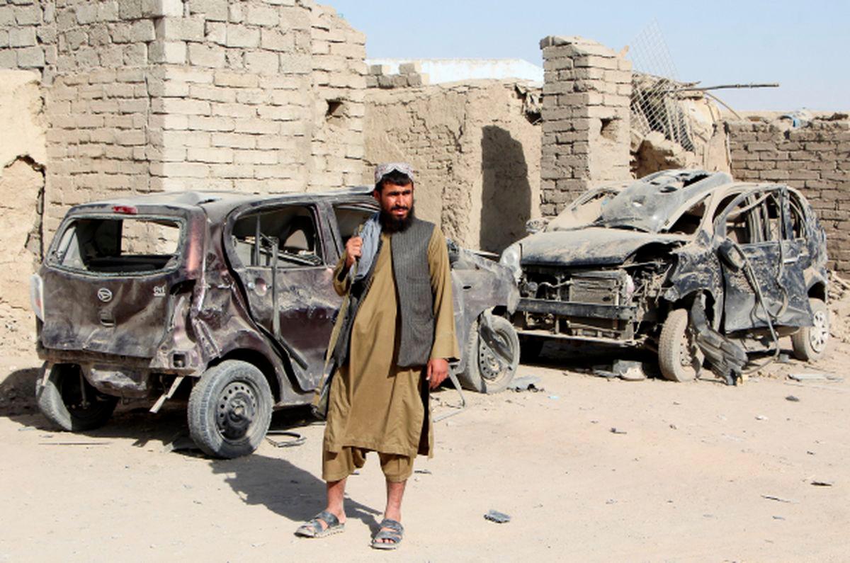 A Taliban fighter stands next to vehicles destroyed during an airstrike, following a temporary ceasefire, amid the conflict between Afghanistan and Pakistan, in Spin Boldak district of Kandahar Province, Afghanistan, October 16, 2025. - REUTERSPIX