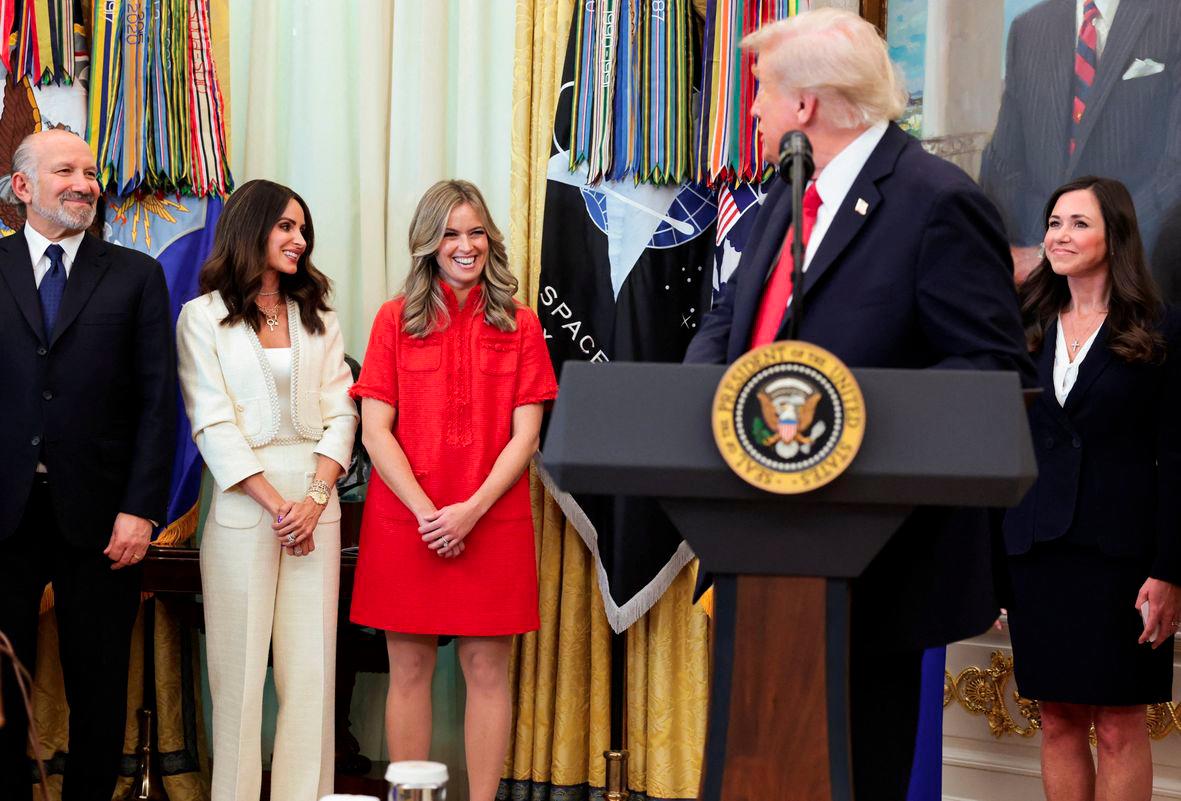 Libby Horne, EMD Serano Senior Vice President of US Fertility &amp; Endocrinology, reacts during an annoucement by U.S. President Donald Trump on fertility treatment coverage, as U.S. Secretary of Commerce Howard Lutnick, IVF advocate Samantha Busch and U.S. Senator Katie Boyd Britt (R-AL) look on, at the White House in Washington, D.C., U.S., October 16, 2025. - REUTERSPIX