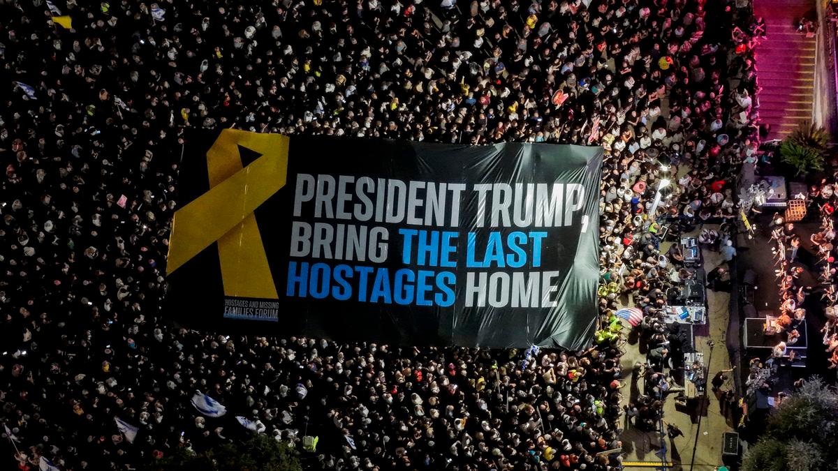 A drone view shows participants holding a large banner during a rally held by hostage families and supporters at “Hostages Square” to demand the immediate release of the bodies of the deceased hostages who were kidnapped in the deadly October 7, 2023, attack on Israel by Hamas, in Tel Aviv, Israel, October 18, 2025. REUTERS/Ilan Rosenberg