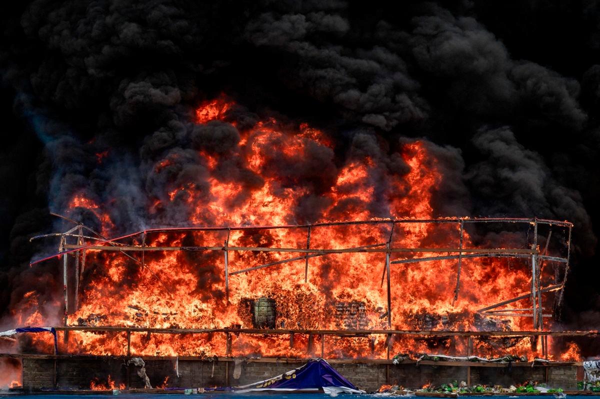 Smoke rises during a destruction ceremony of seized illegal drugs in Yangon on June 26, 2025. (Photo by Sai Aung Main / AFP)