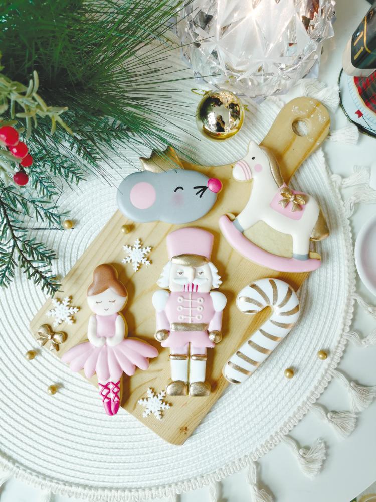 A set of Christmas cookies comprising ballerina, nutcracker, candy and others. The cookies were made by Valene Lam