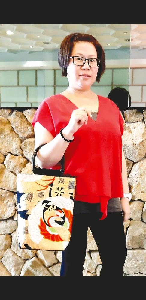 $!Ong carrying one of her own creations. – Courtesy of Shirley Ong