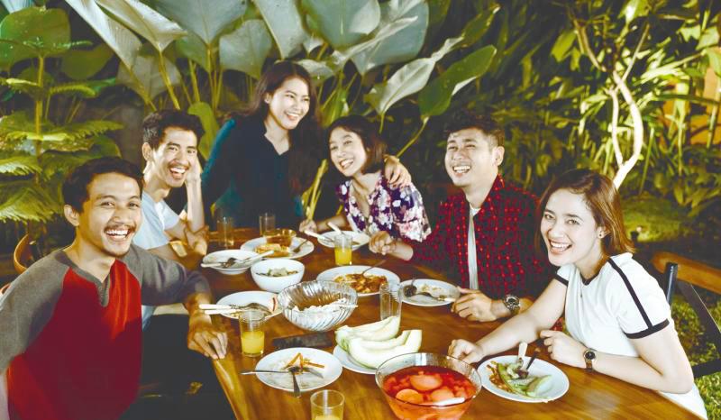 A house party could be as simple as having friends over to catch up over a meal. - 123RF
