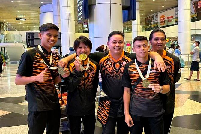 National muay thai coach Bernard Radin (centre) and his team upon returning home from the Cambodia for the 2023 SEA Games//BernardRadinFBpix