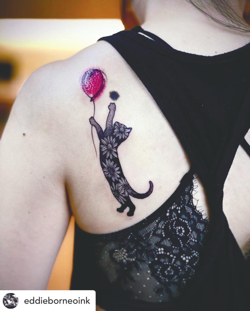 A playful cat tattoo by Eddie. - BORNEO INK TATTOO
