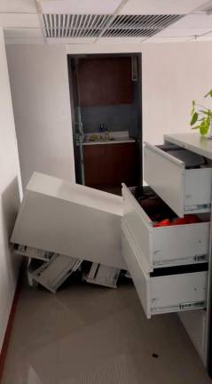 A cabinet lies on the floor following an earthquake of magnitude 7.5 that struck offshore in the southern Philippines, in Davao City, Mindanao, Philippines, October 10, 2025 in this screen grab obtained from a social media video. Francis Magbanua/via REUTERS