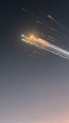 Orange balls of light fly across the sky as debris from a SpaceX rocket launched in Texas is spotted over Turks and Caicos Islands, January 16, 2025 in this screen grab obtained from social media video. Marcus Haworth@marcusahaworth/via REUTERS