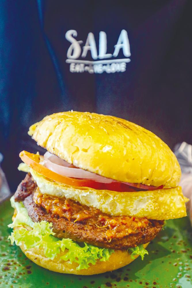 The newly launched SALA Burger Belacan. - AMIRUL SYAFIQ/THESUN