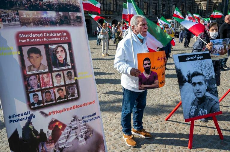 A man holds a portrait of executed Iranian wrestler Navid Afkari during a demonstration in Amsterdam on Sept 13, 2020. — AFP