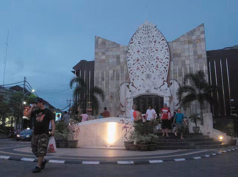 A tourist crosses the street from the Ground Zero Monument in Kuta, Bali - REUTERSpix