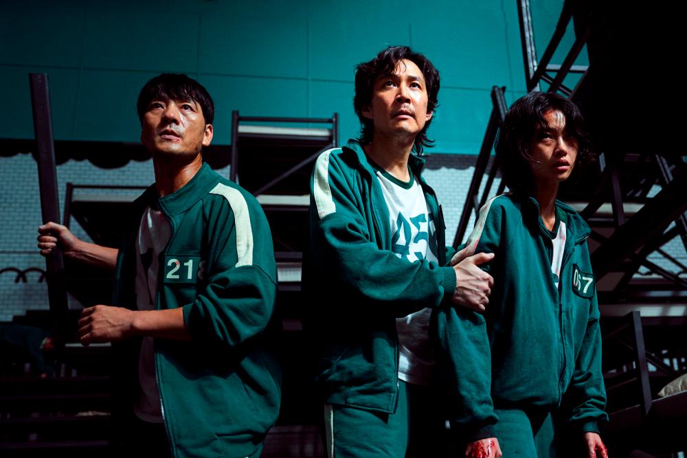 The final three (from left) Park Hae Soo as Cho Sang Woo, Lee Jung Jae as Seong Gi Hun, and Jung Ho Yeon as Kang Sae-byeok. — PHOTO COURTESY OF NETFLIX