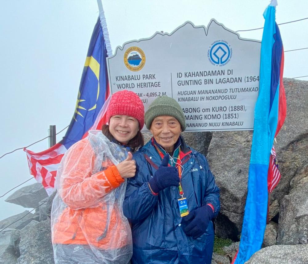 Nonagenarian Buatin Balandong (right), who reached the summit of Mount Kinabalu for the eighth time last Sept 5 attributes his feats to strong willpower and determination. Pix credit: Facebook/Monica Suleiman