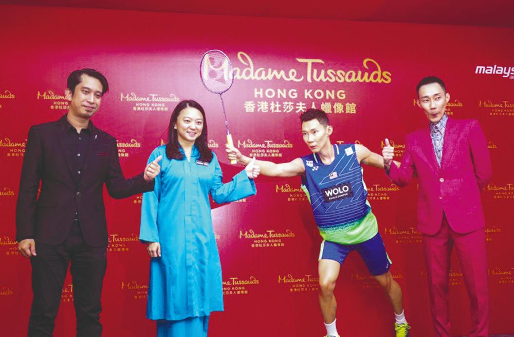 $!(from right) Adam, Yeoh and Lee with the wax figure.