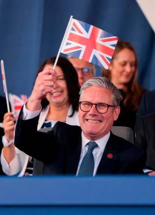 Britain’s Prime Minister Keir Starmer waves a Union flag during a concert to mark the 80th Anniversary of VE Day at Horse Guards Parade on May 08, 2025 in London, England. Chris Jackson/Pool via REUTERSpix
