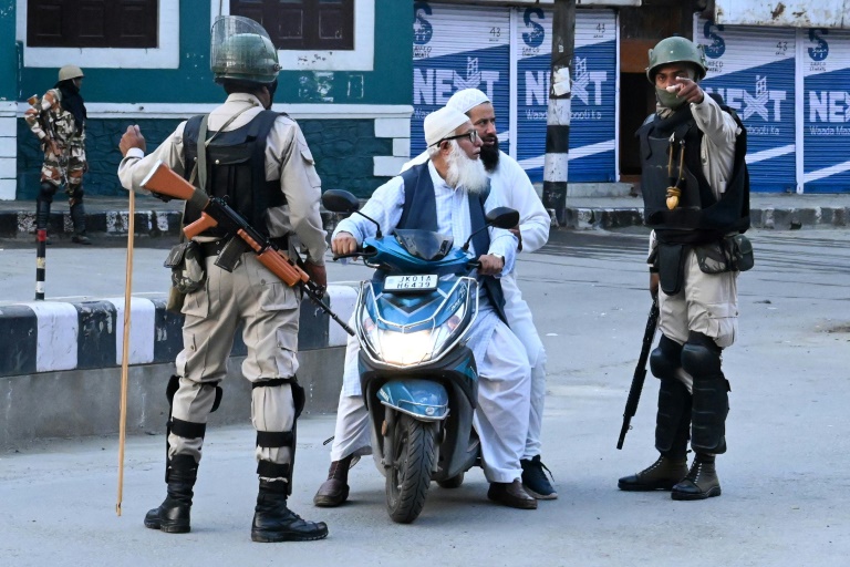 Security personnel stop Muslims for questioning during a lockdown in Kashmir’s main city Srinagar. — AFP