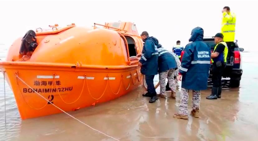 Members of the police and Maritime Malaysia inspect the rescue boat that was found stranded at Trombol Beach, Kuching. Photo Courtesy of APMM