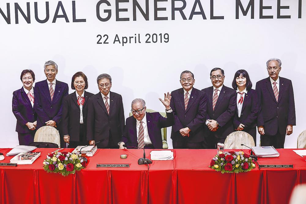 Public Bank founder and chairman emeritus Tan Sri Teh Hong Piow (seated), Tay (fourth from left) and management staff at the AGM today. – Adib Rawi Yahya/theSun