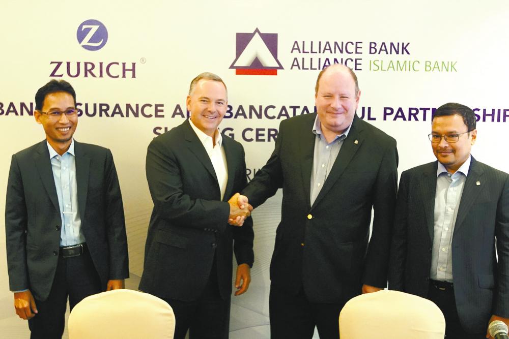 From left: Zurich General Takaful CEO Zuhairi Ismail, Fike, Kornreich and Alliance Islamic Bank CEO Rizal Il-Ehzan Fadil Azim at the signing ceremony today. – NORMAN HIU/theSun
