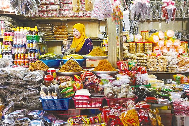 A stall keeper tends to her stall at a market in Kota Baru, Kelantan. – REUTERSPIX