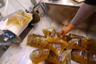 Food court trader faces legal action for selling subsidised cooking oil packs to foreigners