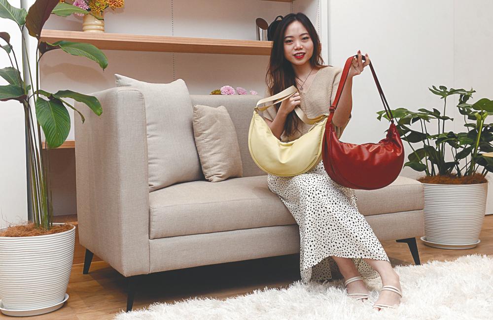 $!Fashion influencer Ariel Chin posing with bags in different colours.