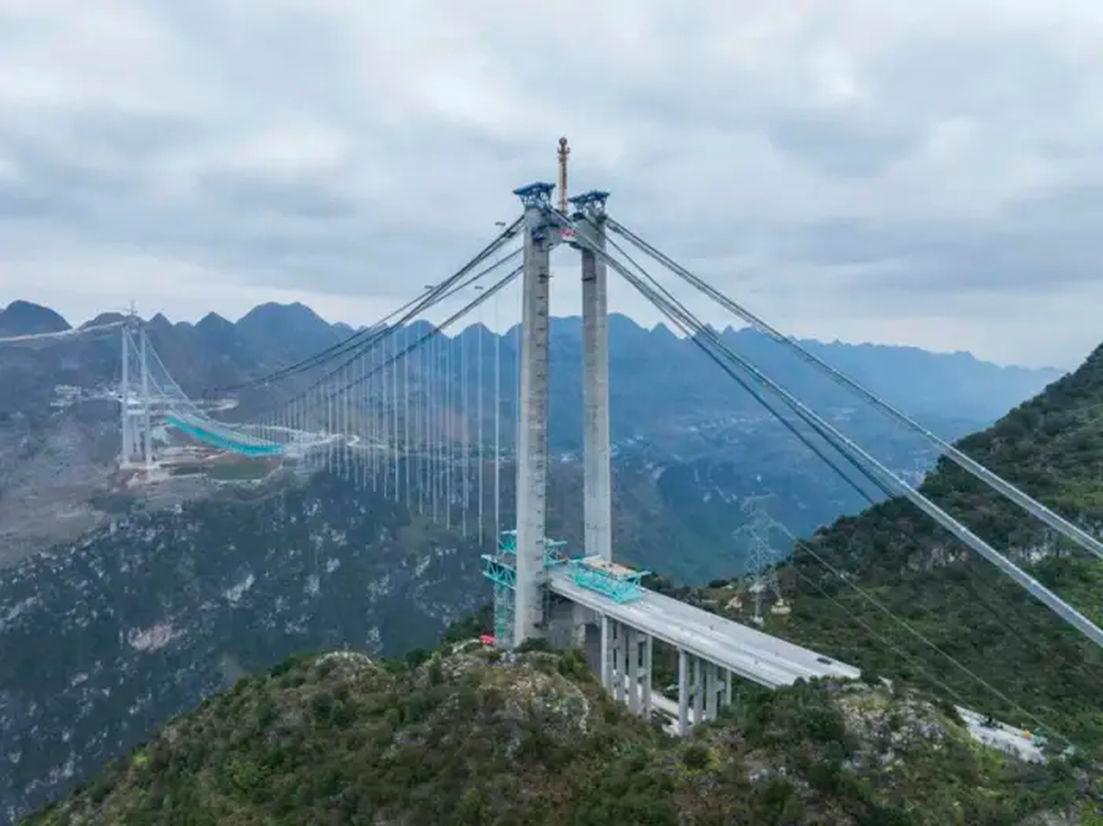 The Huajiang Grand Canyon Bridge is seen under construction on November 27, 2024, in China’s Guizhou province. - China News Service/VCG via AP