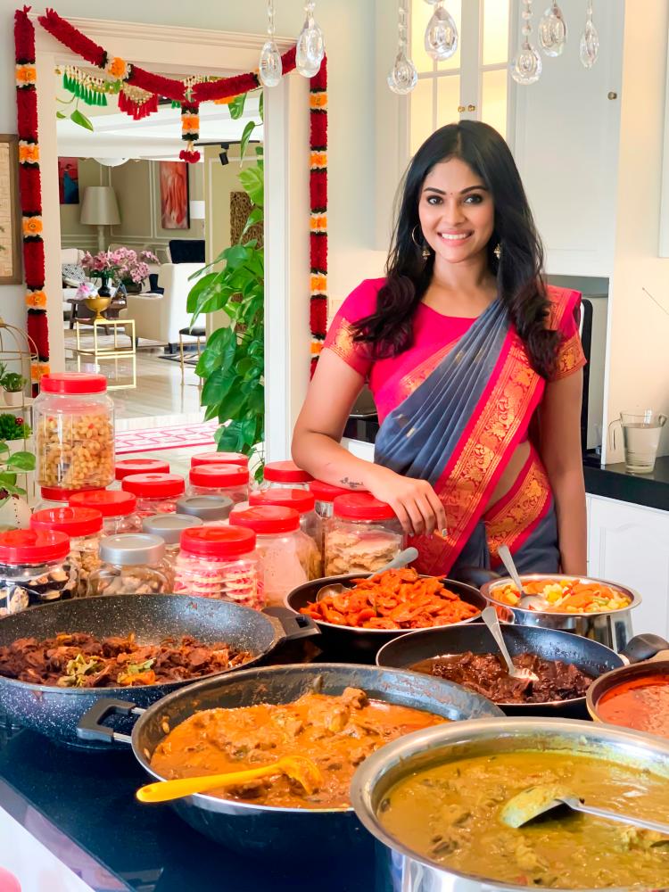 Santhi with some of her homecooked dishes. – PICTURE COURTESY OF SANTHI RAJBARR