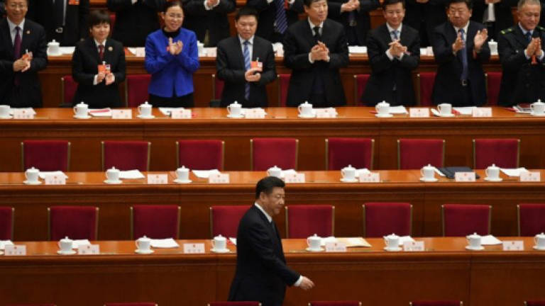 Chinese President Xi Jinping was applauded as he arrived for the key vote at the National People’s Congress. — AFP