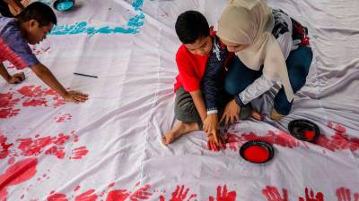 Disabled students express national pride with handprint Jalur Gemilang