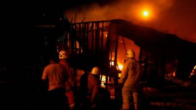 Eight houses destroyed in fire, woman injured