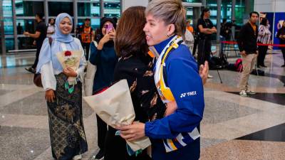 Parents proud as Tang Jie-Ee Wei return as badminton world champions