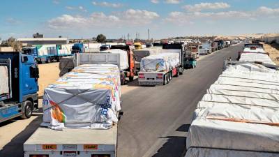 Aid trucks enter Gaza as hostage bodies dispute pauses at Rafah