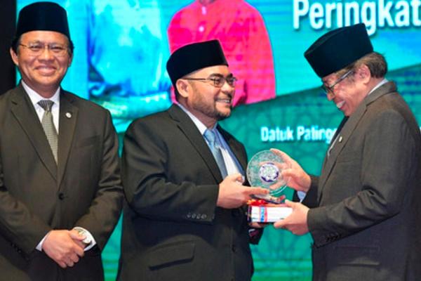 Minister in the Prime Minister’s Department (Religion), Datuk Seri Dr Mujahid Yusof plaque from Sarawak Chief Minister Datuk Patinggi Abang Johari Tun Openg. — Bernama
