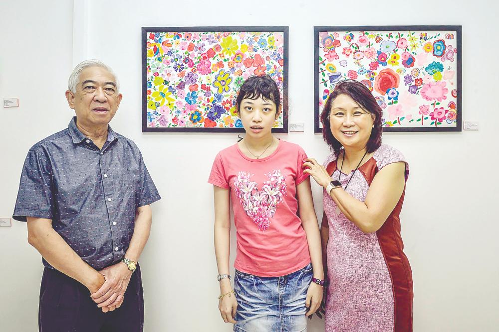 Moi (right) with her husband and late daughter. – ADIB RAWI YAHYA/THESUN