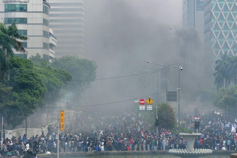 Smoke rises from fires set by activists during protests in Jakarta. — AFP