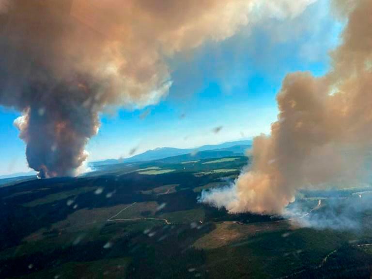 This handout photo courtesy of BC Wildfire Service shows two plumes of smoke from the Long Loch wildfire and the Derrickson Lake wildfire, British Columbia, on June 30, 2021. — AFP