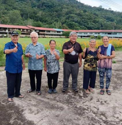 Sarawak native rights activist Michael Jok (centre in black t-shirt) with his native folks in Belaga longhouse where mud roads and rotting bridges are as common as floods. Michael Jok pic